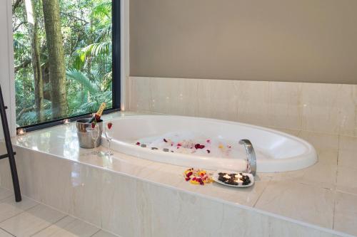 a bath tub with a plate of food in it at Pethers Rainforest Retreat in Mount Tamborine