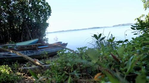 a boat sitting on the shore of a lake at Hello Homestay in Galle