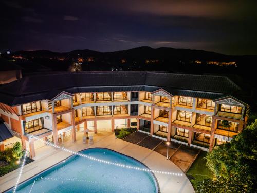 an aerial view of a building with a swimming pool at Eco Hotel by Thammasat in Bang Lamung