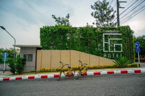 a couple of bikes parked on the side of a street at Eco Hotel by Thammasat in Bang Lamung