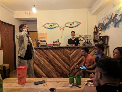 a man standing in a room with a group of people at Mochilero Ostello in Pelling