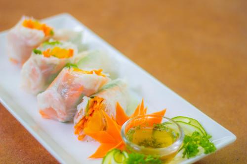 a plate of food with sushi on a table at Mithi Resort & Spa in Panglao
