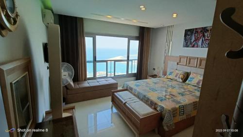 a bedroom with a bed and a view of the ocean at Gleem Luxury Condo Direct Sea view G18 in Alexandria