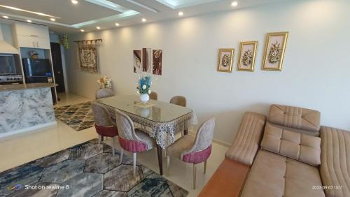 a dining room with a table and chairs at Gleem Luxury Condo Direct Sea view G18 in Alexandria