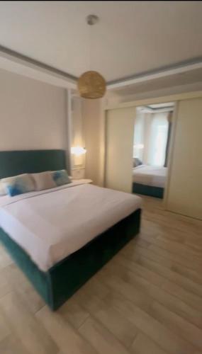 a bedroom with a large bed and a window at Property Sisters, Elite new studio B6 in Madinaty