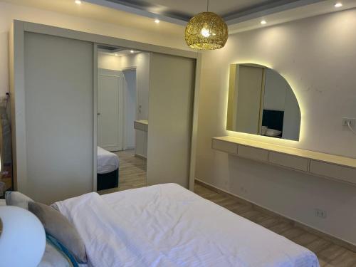 a bedroom with a bed and a mirror at Madinaty, Elite new studio families and married couples only in Madinaty