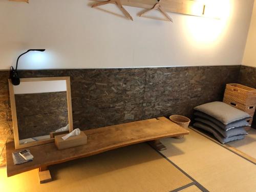 a room with a table and a mirror and a stool at 離島-宿navelの学校-三原港から船で14分 in Mihara
