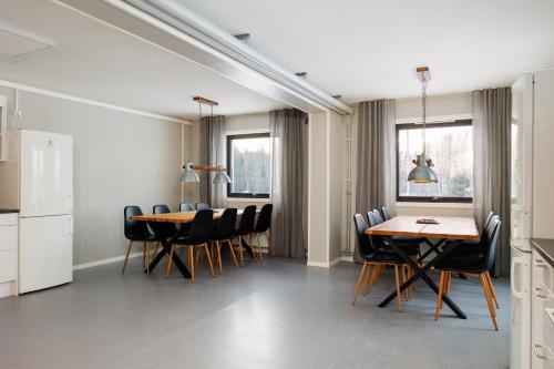 a kitchen and dining room with a table and chairs at Western Farm Village in Boden