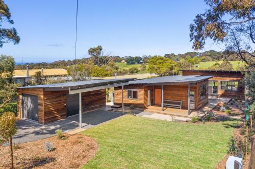 a wooden house with a large yard at Naturally Shoreham in Shoreham