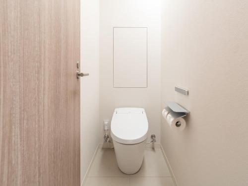 a bathroom with a white toilet in a room at Hotel Il Palazzo in Fukuoka