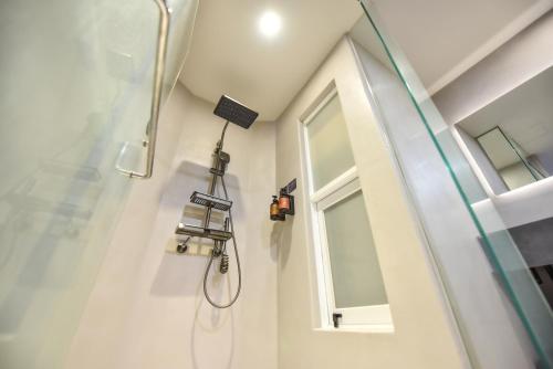 a shower in a bathroom with a window at Two Couples Leisure Art Motel in Tainan