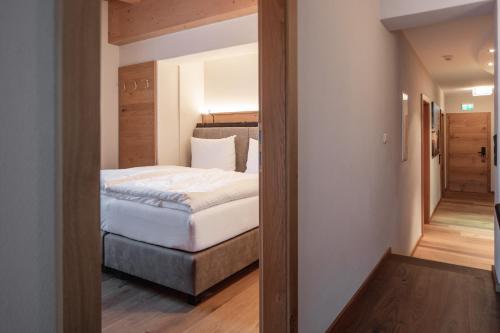 a bedroom with a large bed in a room at Hotel Salzburg in Saalbach Hinterglemm