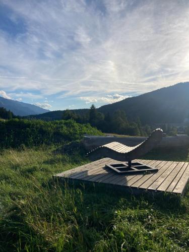a bench sitting on a wooden table in a field at RELAX Seefeld Apartman in Seefeld in Tirol