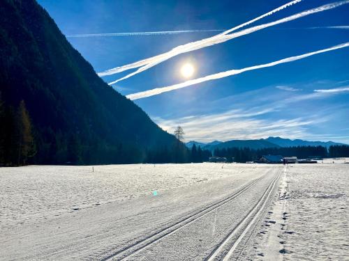 a snow covered field with tracks in the snow at RELAX Seefeld Apartman in Seefeld in Tirol