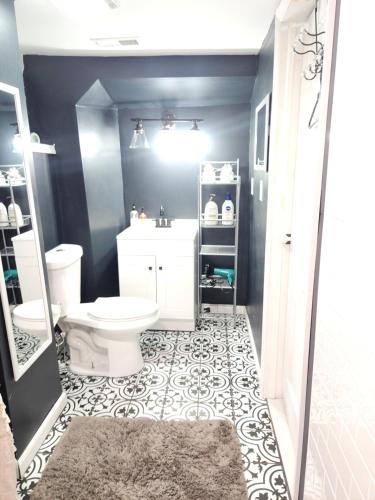 a bathroom with a toilet and a sink at Lovely Private 2 Bedroom Suite near EWR/NYC in Newark
