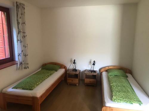 pokój z 3 łóżkami i oknem w obiekcie Döröcske Vendégház w mieście Somogydöröcske