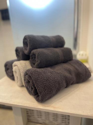 a pile of towels sitting on a shelf in a bathroom at Topsleep Apartments 24-2 in Arnhem