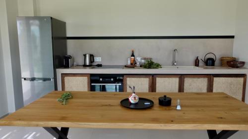a wooden table in a kitchen with a counter at Pnoe Eco Residences in Amaliás