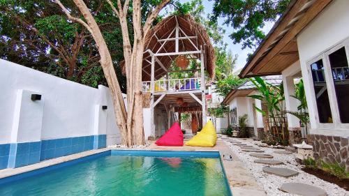 a house with a swimming pool with colorful pillows at Panda Home in Gili Trawangan