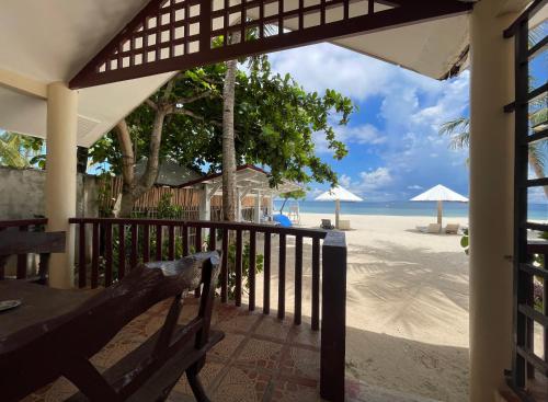 a view of the beach from the porch of a resort at Beach Placid Resort powered by Cocotel in Ocoy