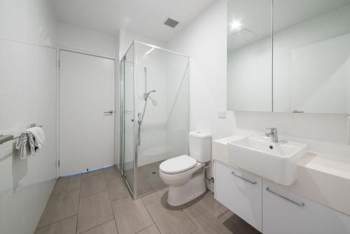 a bathroom with a toilet and a sink and a shower at Apartment Living on the Beach in Rosebud