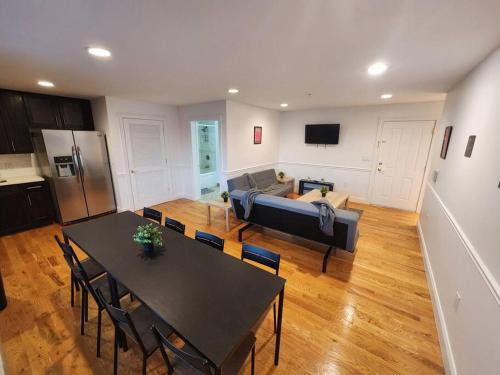 a living room with a table and a couch at Luxurious 2 bed ! mins to NYC! in Union City