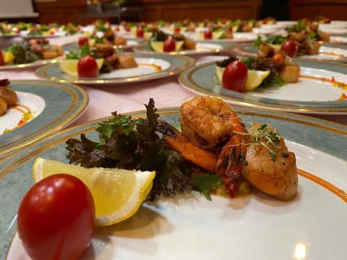 a plate of food with shrimp and vegetables on a table at Park Avenue Hotel Sungai Petani in Sungai Petani