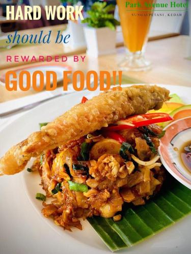 a plate of food on a table with a plate of food at Park Avenue Hotel Sungai Petani in Sungai Petani