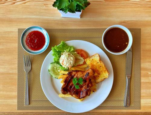 a plate of food with meat and vegetables and sauce at Park Avenue Hotel Sungai Petani in Sungai Petani
