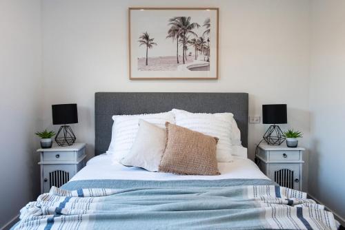 a bedroom with a bed with two night stands at Waterfall Gully Retreat with Gas heated Pool in Rosebud
