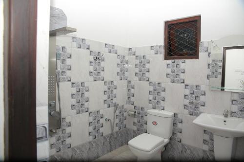 a bathroom with a toilet and a sink at Villa71 in Galle