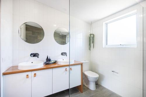 拉伊的住宿－Driftwood Family Oasis in Rye，白色的浴室设有水槽和卫生间。