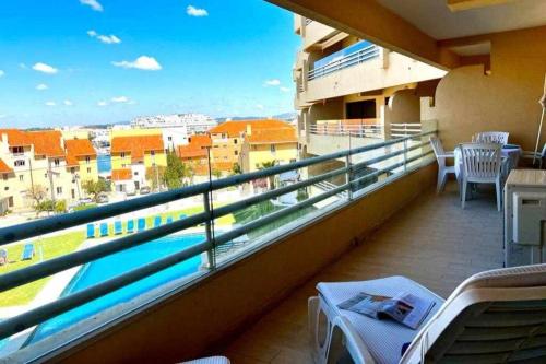 a balcony with a view of a city at Marina Mar by FHR piscina, parking in Quarteira
