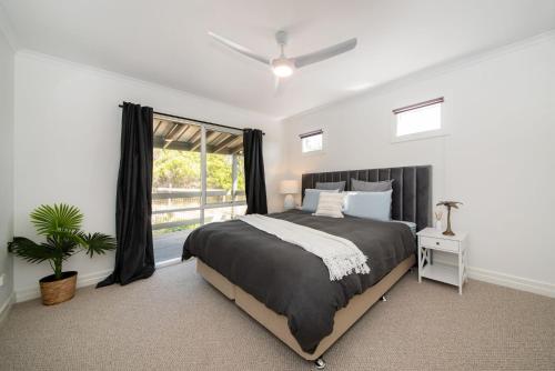 a bedroom with a large bed and a window at Dundas on the Beach at St Andrews in Saint Andrews Beach