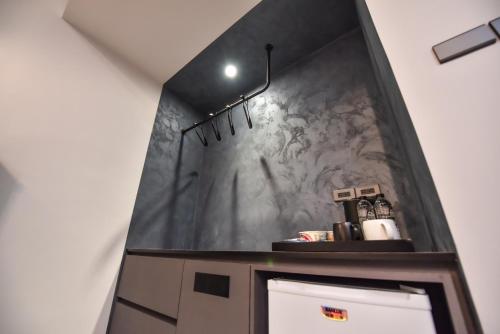 a bathroom with a sink and a wall at Two Couples Leisure Art Motel in Tainan