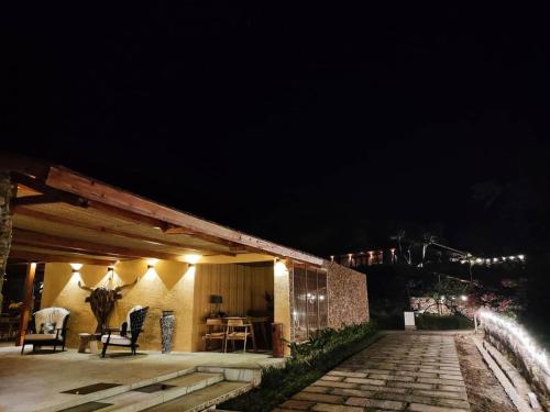 a house at night with lights on it at Lobster Bay Lombok in Awang