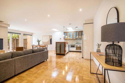 a living room with a couch and a table at Elwood Sanctuary in Melbourne