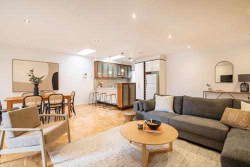 a living room with a couch and a table at Elwood Sanctuary in Melbourne