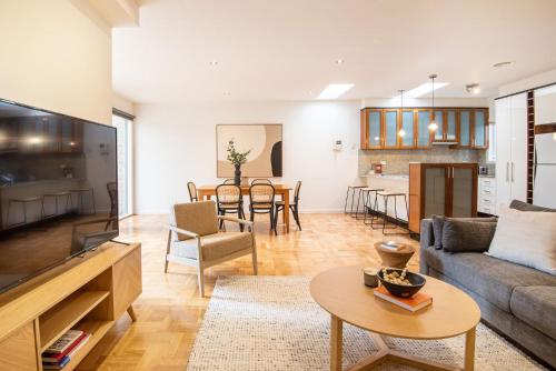 a living room with a couch and a table at Elwood Sanctuary in Melbourne