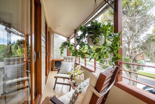a room with a balcony with chairs and plants at Bayside Oasis in Highett in Highett