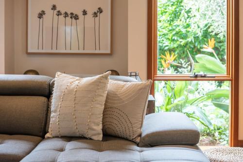 a couch sitting in a living room with a window at Bayside Oasis in Highett in Highett