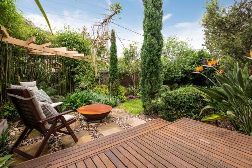 a patio with a chair and a table in a garden at Bayside Oasis in Highett in Highett