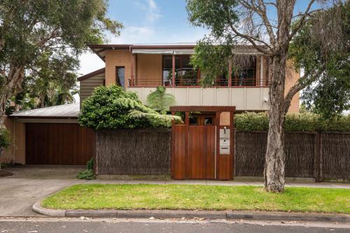 a house with a wooden gate in front of it at Bayside Oasis in Highett in Highett