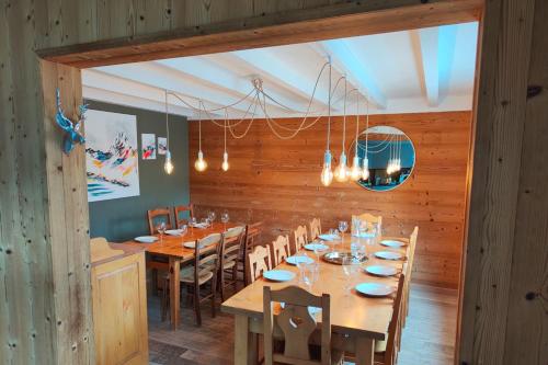 a dining room with a long table and chairs at Chalet Alpina in Les Deux Alpes