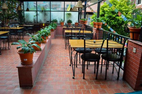 a patio with tables and chairs and potted plants at Thamel Grand Hotel in Kathmandu