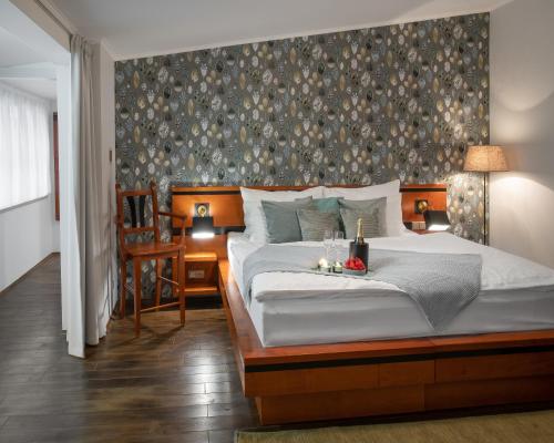 a bedroom with a large bed with a wall at 4 Elements Apartments by Adrez in Prague