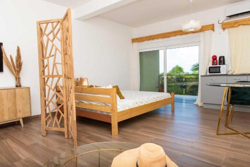 a bedroom with a bed and a ladder at B&Baobab in Bouéni