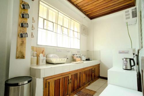 a kitchen with a counter and a window in it at Pallet Homes - Ledesco in Iloilo City