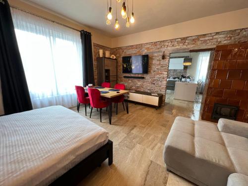 a bedroom with a bed and a table and chairs at Casa Armoniei in Baia Mare
