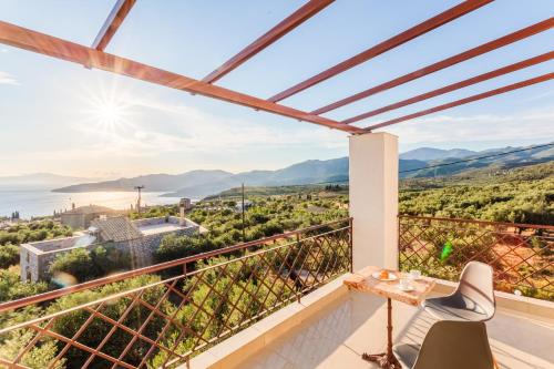 a balcony with a view of the ocean and mountains at Villa Armonia, Sunset View and Relaxing Beach Vibe in Proástion